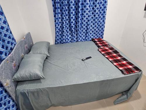 a bed in a room with a couch with a blanket at starbox dream vacation & car rentals in Nadi