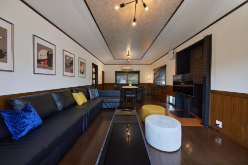 a living room with a blue couch and a table at IZA cominca 萬 in Kameoka