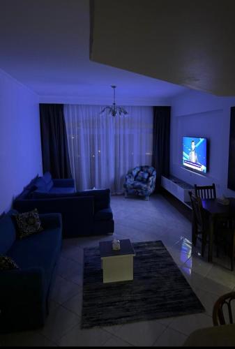 a living room with a couch and a tv at Super 2 bedroom apartment in Naama bay in Sharm El Sheikh