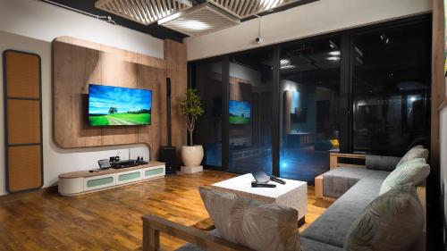 a living room with a couch and a tv at Jambuluwuk Bromo Poshtel in Pasuruan