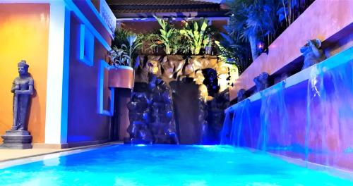 a swimming pool in a building with a fountain at HIDELAND Luxury Pool Villa Pattaya Walking Street in Pattaya South