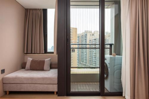 a room with a balcony with a bed and a window at Mido International Hotel in Guangzhou