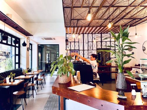 a man sitting at a bar in a restaurant at Lavanya Boutique Hotel in Phnom Penh