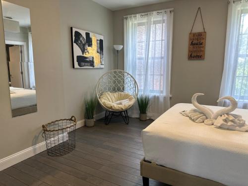 a bedroom with a bed and a mirror and a chair at Bright & Airy 1 BDRM Private Apt in Albany