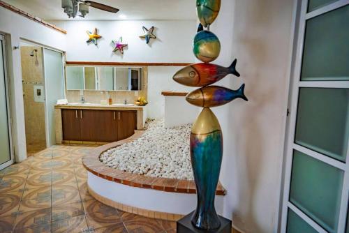 a room with a bed with fish on the wall at Oceanfront 4BR 20 PAX in Puerto Vallarta
