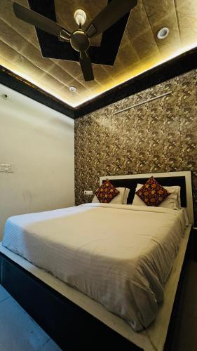 a bedroom with a bed with a ceiling fan at Nahargarh view Hotel in Jaipur
