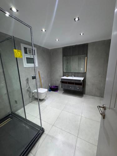 a bathroom with a shower and a toilet and a sink at The Royal Sea View Suite in Port Said