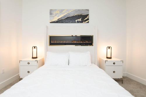 a bedroom with a white bed with two night stands at The Modern Suite Residences in Glendale