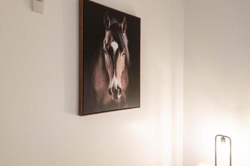 a picture of a horse on a wall at The Modern Suite Residences in Glendale