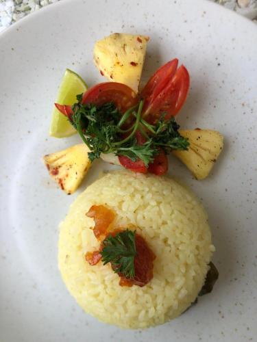 a plate of food with rice and vegetables on it at Ovenro Hotel Yala, Kataragama in Kataragama