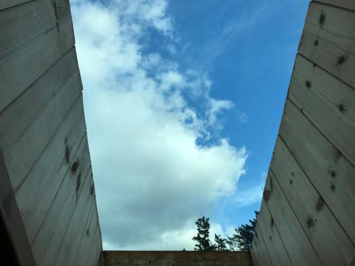 a view of the sky from between two buildings at Yanggang house in jeju in Kosŏng-ni