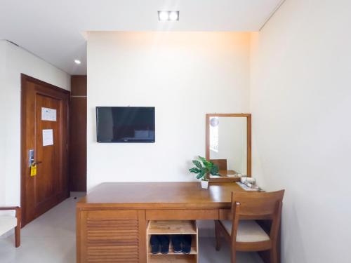 a room with a wooden desk and a mirror at Doha Central Bliss Danang Hotel by Haviland in Da Nang