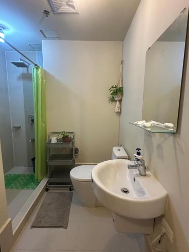 a bathroom with a sink and a toilet and a shower at Tagaytay Zen Escape in Iruhin