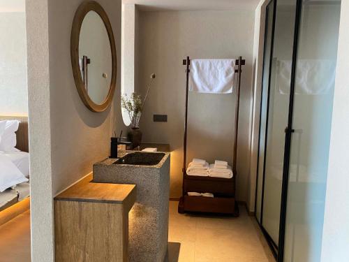 a bathroom with a shower and a sink and a mirror at Siguniang Mountain Star Moon Cliff Hotel in Mount Siguniang