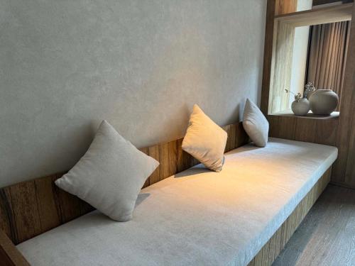 a bed with two pillows on it in a room at Siguniang Mountain Star Moon Cliff Hotel in Mount Siguniang