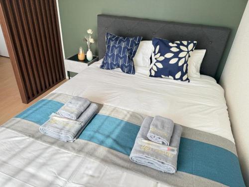 a bed with towels and pillows on it at nestay apartment tokyo skytree in Tokyo