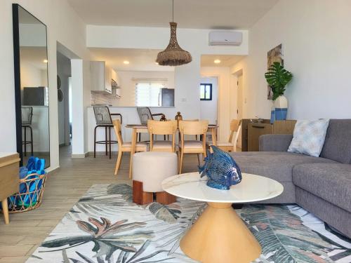 a living room with a couch and a table at Ona Residences Punta Cana in Punta Cana