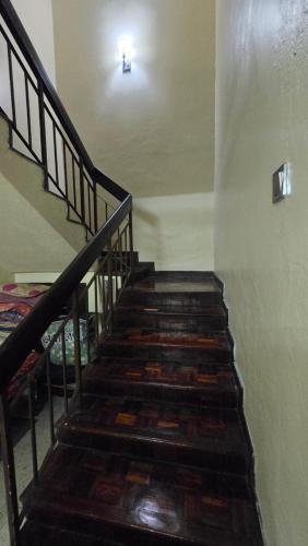 a staircase in a building with a light on the ceiling at D Santai Homestay in Kuala Terengganu