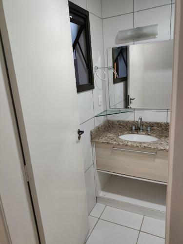 a bathroom with a sink and a mirror at Apartamento com vista para lagoa in Caxias do Sul