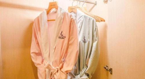 a group of shirts are hanging on a rack at Lavande Hotel Yichang Railway East Station Branch in Yichang