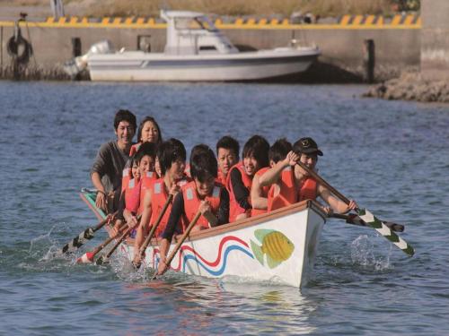 a group of people in a boat in the water at Nature Miraikan in Naha