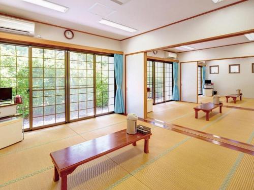 a living room with a table and some windows at Nature Miraikan in Naha
