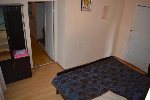 a bedroom with a bed in the corner of a room at Mziuri Guest House in Mestia