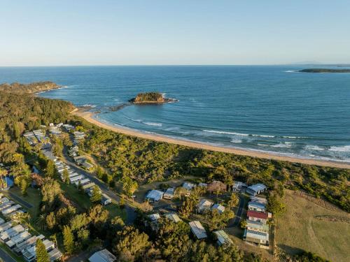 an aerial view of a beach and the ocean at Barlings Beach Holiday Park in Tomakin
