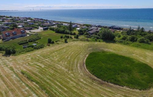 an aerial view of a field next to the ocean at 4 Bedroom Beautiful Home In Slagelse in Slagelse