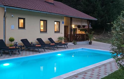 a swimming pool in front of a house at Lovely Home In Tuhelj With Sauna in Tuhelj