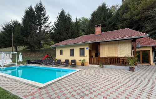 a house with a swimming pool in front of it at Lovely Home In Tuhelj With Sauna in Tuhelj