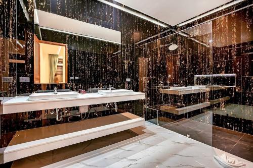 a bathroom with two sinks and a mirror at Palm Villa - Spacious 4 Bedrooms with Private Pool in Rawai Beach