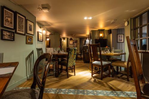 a dining room with a table and chairs at Greyhound Hotel in Sutton