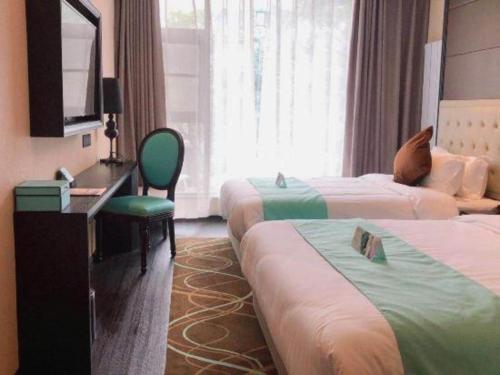 a hotel room with two beds and a desk at Xana Hotelle Xi'an Zhonglou, Huimin Street Metro Station in Xi'an