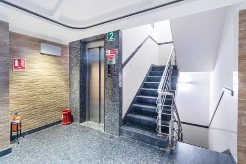 a stairwell in a building with a stair case at Hotel O Platinum Inn in Bengaluru