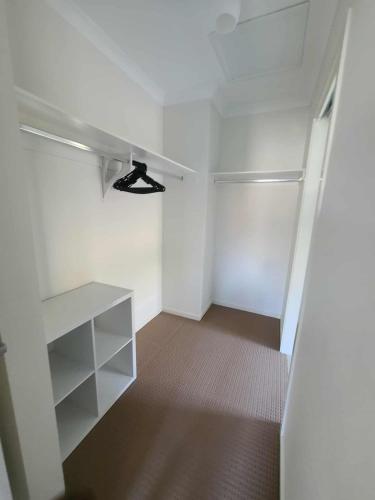 an empty room with a closet with a ceiling fan at Executive Family Home in Benalla
