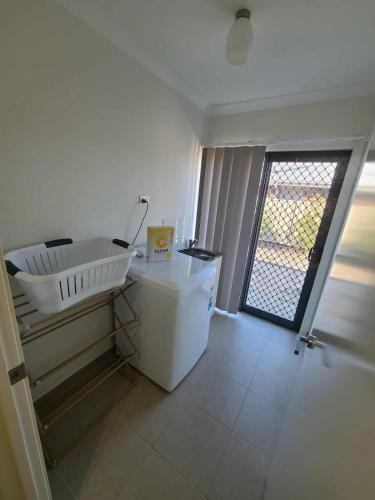 a room with a sink and a door with a window at Executive Family Home in Benalla