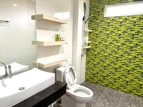 パタヤ・サウスにあるWarisa Happy Pool Villa Near Pattaya Beachの白いトイレと洗面台のあるバスルーム