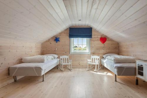 a room with two beds and a window at Modern Family Cabin Near Vinterland Ski Resort in Lifjell