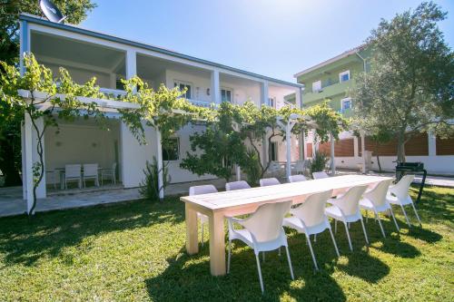 a table and chairs in front of a building at Jaz Garden Residence in Budva