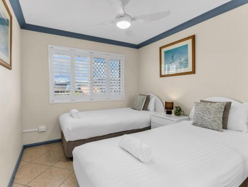a bedroom with two beds and a window at Cabarita Beachfront Ocean View 12 in Cabarita Beach