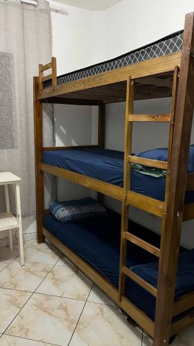 a bunk bed with blue bunk beds in a room at Hostel Pedacinho do Céu in Barueri