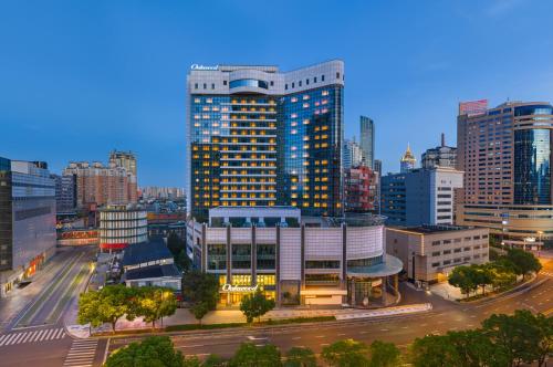 a city skyline with tall buildings and a street at Oakwood Central Wuxi in Wuxi