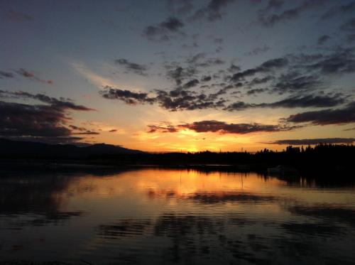 a sunset over a body of water with the sky at Estuary House Reflexology B&B in Courtenay