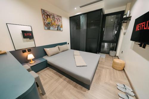 a small room with a bed and a table at Alumas Home in Hanoi