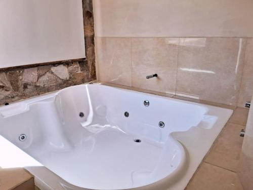 a large white bath tub in a bathroom at canto del viento in Tilcara