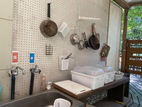 a kitchen with a sink and some pots and pans at Glamping Himeshara - Vacation STAY 43046v in Kirishima