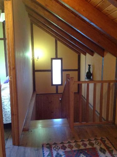 a room with a stairway with a window and a stair case at El Mirador de los Trobos in Villar de Otero