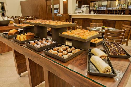 a buffet with many different types of food on a table at Meliá Campinas in Campinas