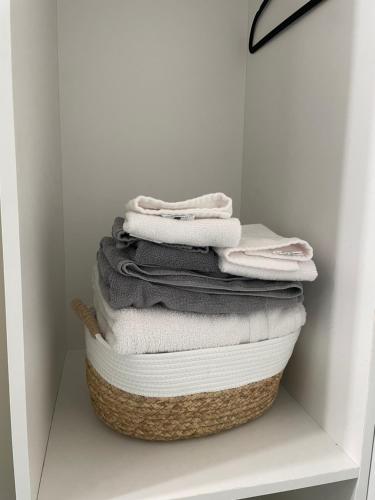 a stack of towels sitting on top of a basket at Central Vally Private House in Abbotsford